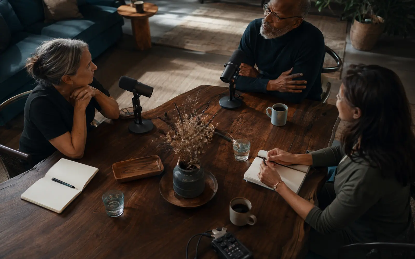 An intimate, beautifully designed recording conversation with real attentive listening, subtle studio equipment and lived-in warmth.