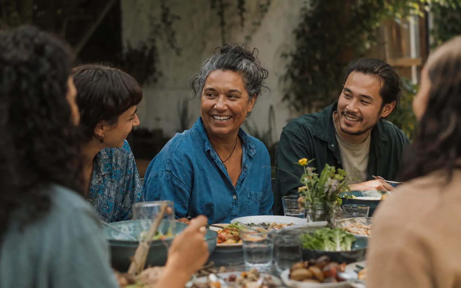 A warm communal meal or garden activity that makes wellbeing tangible and inclusive.