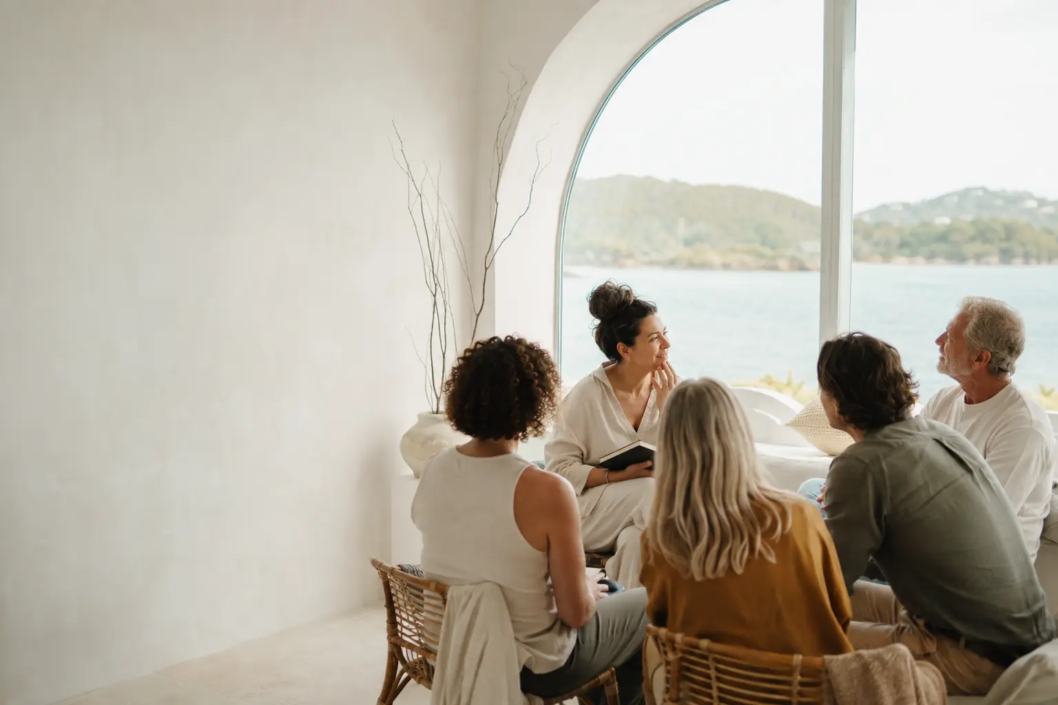 People in a thoughtful, human conversation by the water